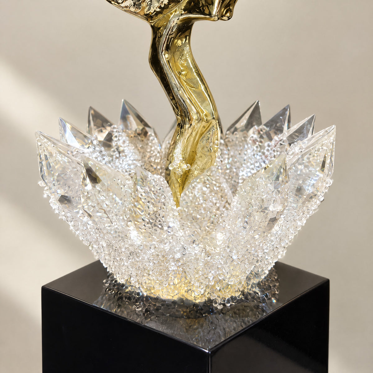 Close-up of the faceted K9 crystal lotus filled with crystal chips, on a glossy black glass base