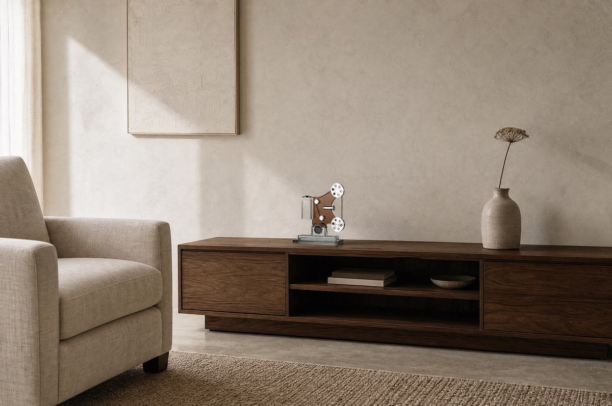 Crystal film projector sculpture on a walnut media cabinet in a quiet room, showing its 29 cm size