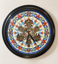 Garden Aura wall clock with a stained-glass dial and gold gears in a black metal frame, front view on an ivory wall