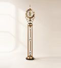 Imperial Crystal Column floor clock in brass finish, 165 cm tall, with cut-glass crystal along an open four-rod column, on an ivory background