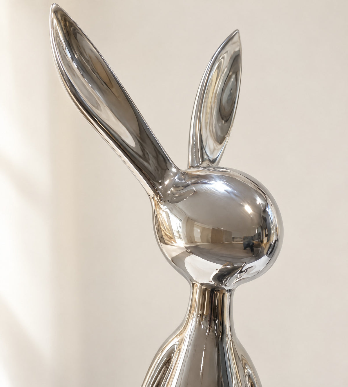 Close-up of the chrome bunny's faceless head and two long ears