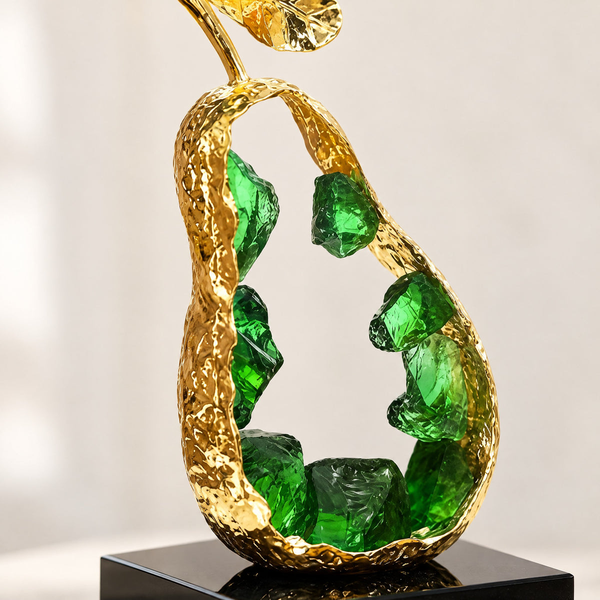Close-up of raw green K9 crystal chunks inside the hammered gold pear shell